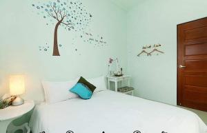 Vuode tai vuoteita majoituspaikassa Yilan Greenbird of Happiness B&B
