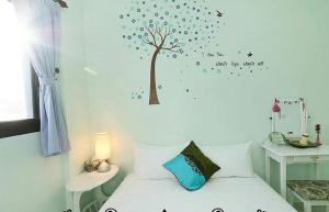 Vuode tai vuoteita majoituspaikassa Yilan Greenbird of Happiness B&B