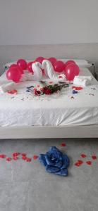 a bed with red and white flowers on the floor at Il corallo azzurro in Reggio di Calabria