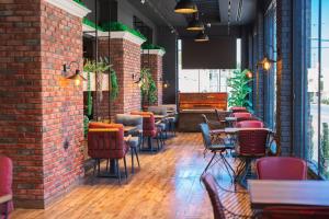 a restaurant with chairs and tables and a brick wall at Sanmoris Hotel 