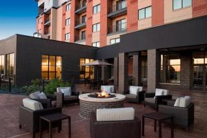 a patio with chairs and a fire pit in front of a building at Courtyard by Marriott Mt. Pleasant at Central Michigan University in Mount Pleasant