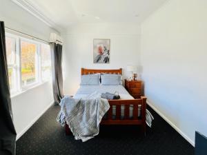 a bedroom with a bed with a person laying on it at Talbingo Lodge - Selwyn Accommodation in Talbingo