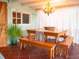 a dining room with a table and benches at Utopia Guesthouse & Yoga Studio beachfront home in El Cuyo +56 photos