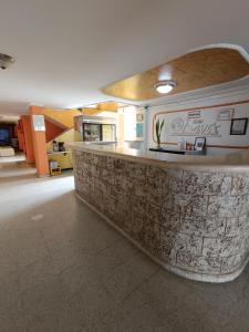 a lobby with a counter in a building at Hotel Danes Barranquilla in Barranquilla