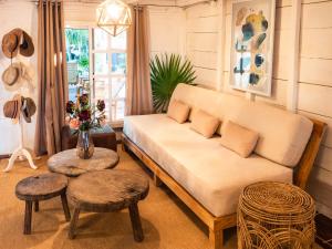 a living room with a couch and a table at Utopia Guesthouse & Yoga Studio beachfront home in El Cuyo
