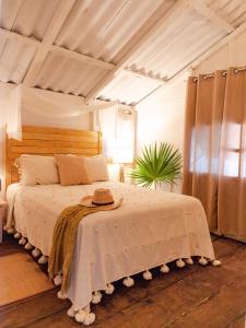 a bedroom with a bed with a hat on it at Utopia Guesthouse & Yoga Studio beachfront home in El Cuyo +56 photos
