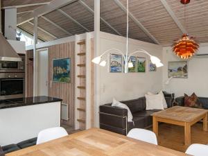 a living room with a couch and a table at 8 person holiday home in Glesborg in Glesborg