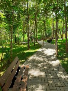 a park with benches and trees and a walkway at HOTELParque Veredas flat 327 VISTA PARA PISCINA ASCESSO AO RIO AO LADO DO HOT PARK FABULOSO in Rio Quente