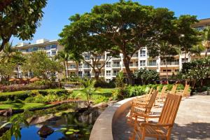 a group of chairs and a pond in front of a building at The Westin Ka'anapali Ocean Resort Villas in Lahaina