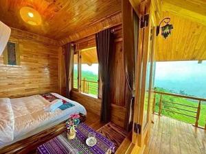 a bedroom with a bed and a large window at Hmong Eco Villas in Sa Pa