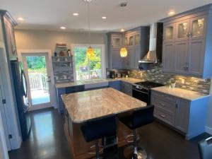 a kitchen with a large island with a counter top at Sanctuary at edge of forest in Ladysmith
