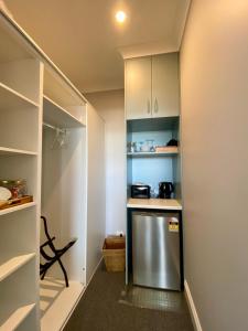 a kitchen with a stainless steel refrigerator and shelves at Number 10 -Queen Room with b/fast in Stanley