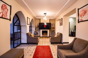 a living room with couches and a fireplace at Villa Warhol Marrakech in Marrakech