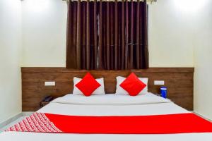 Un pat sau paturi într-o cameră la OYO Flagship Hotel Pink Orchid