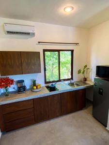 a kitchen with a sink and a refrigerator at Basic Tulum in Tulum