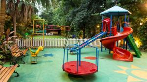 a playground with a red slide at Hare Krishna Home Stay in Vrindāvan
