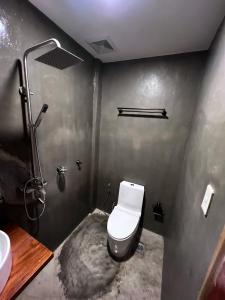 a bathroom with a toilet and a sink at M-Resort Siargao in General Luna