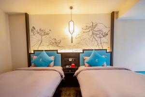 Gongxili-Xijian Hotel - Kunming Dongfeng East Road Dashuying Metro Station客房内的一张或多张床位