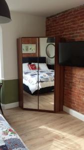 a mirror in a bedroom with a bed at The Railway Inn Westerfield in Ipswich +15 photos