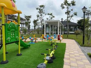 a playground in a park with a bunch of equipment at Blue Sea Hue Hotel in Hue