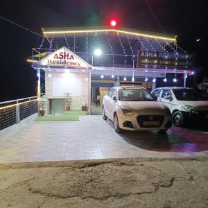 a car parked in a parking lot in front of a asian restaurant at Asha Residency by StayApart in Shimla
