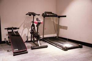 a room with two exercise bikes and a treadmill at Xijian Hotel - Kunming Dongfeng East Road Dashuying Metro Station in Kunming