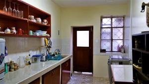 a kitchen with a counter top and a window at Preciosa casa colonial in Quito +9 photos