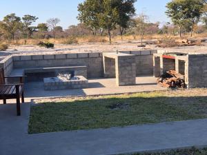 a fire pit and a bench in a park at NAMU Apartments in Katima Mulilo