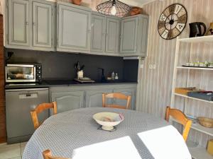 a kitchen with a table with a bowl on it at Le Chalet de Larcat in Larcat