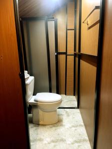 a bathroom with a toilet sitting in a hallway at Yala Wild Safaris Camp in Tissamaharama