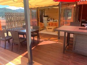 a patio with a table and chairs on a deck at Hakuba Ski Condos in Hakuba