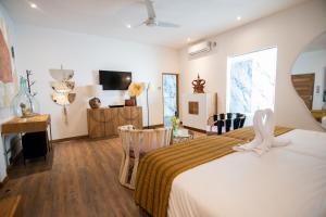 a bedroom with a bed and a table and chairs at Villa Loba in Seminyak