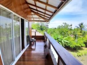 a balcony of a house with a view of the forest at VILLA ENCANTO in El Valle