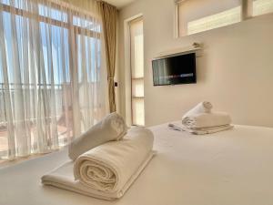 a hotel room with a bed with towels on it at Lighthouse - Private apartment - BSR - 4 in Sveti Vlas