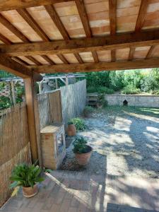 pérgola de madera con macetas en un patio en Il Casale, en Penna San Giovanni