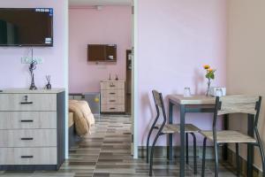 a bedroom with a desk and a table and a bed at The Wish Hotel in Chachoengsao