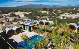 an aerial view of a group of tents in the desert at ChangoMango in La Ventana