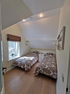 a bedroom with two beds and a window at Harmony Park Nida House in Nida