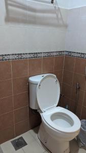 a bathroom with a white toilet in a room at Serene Holiday Chalet with pool in a quiet enclave in Kampong Alor Gajah