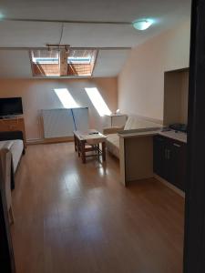 a living room with a couch and a table at Apartmani M-1 in Novi Sad +9 photos