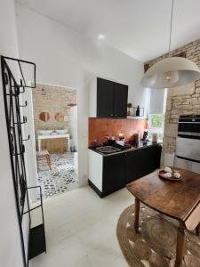 a kitchen with a table and a dining room at Maison Laurenza/ La Liversoise in Saint-Jean-de-Liversay +14 photos