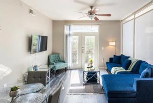 a living room with a blue couch and chairs at Charming 1,100 sq ft apartment near to The Shops at Legacy in Plano