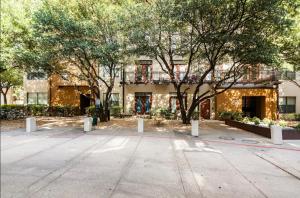 a large building with trees in front of it at Charming 1,100 sq ft apartment near to The Shops at Legacy in Plano