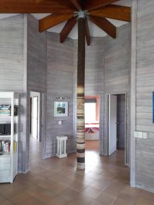 a room with a pillar and a table in it at Sands Villas in Rarotonga