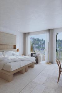 a white bedroom with a large bed and a desk at Canyamel Park Hotel & Spa - 4* Sup - Adults only (+16) in Canyamel