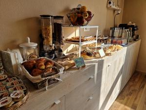 a bakery counter with various types of pastries and bread at U Baruni B&B in Messina