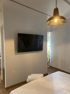 a bedroom with a flat screen tv on a wall at BB Orvieto in Orvieto