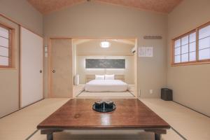 a room with a bed and a table in it at 櫛笥ノ家 Machiya Kushige in Kyoto