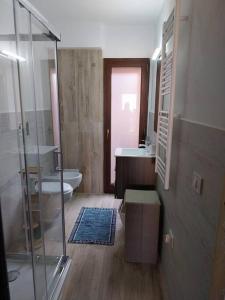 a bathroom with a shower and a toilet and a sink at LA Pavoncella in La Maddalena