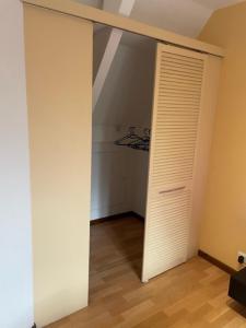 an empty room with a closet and a door at L'authentique - duplex route des vins - Free Wifi in Turckheim